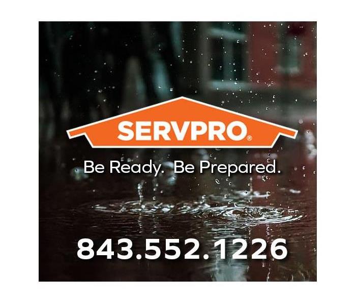 Rain falling on a puddle. SERVPRO logo and local emergency phone number highlighted.